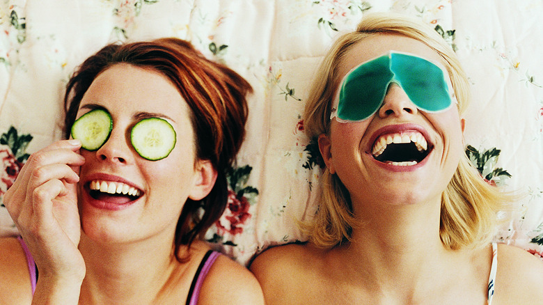 Women wearing eye masks, laughing