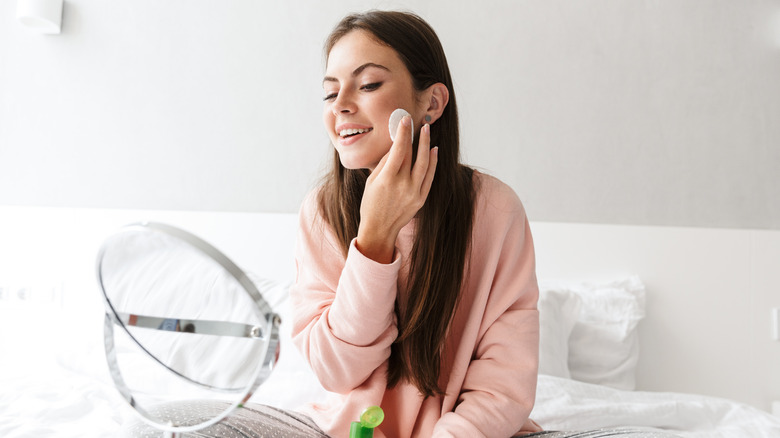 Woman taking off makeup