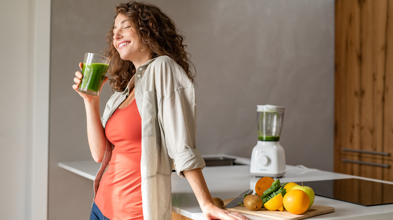 woman drinking morning green smoothie