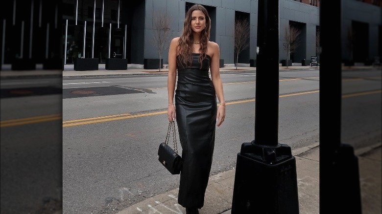 model wearing green leather dress on runway