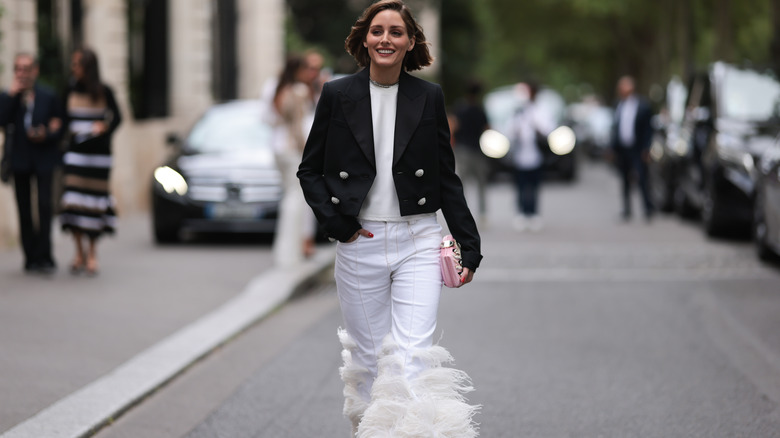 woman wearing white feather pants