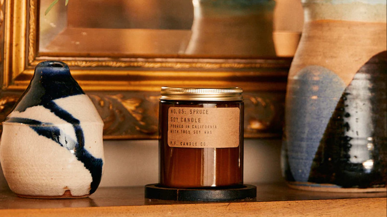 simplistic candle on a wooden shelf