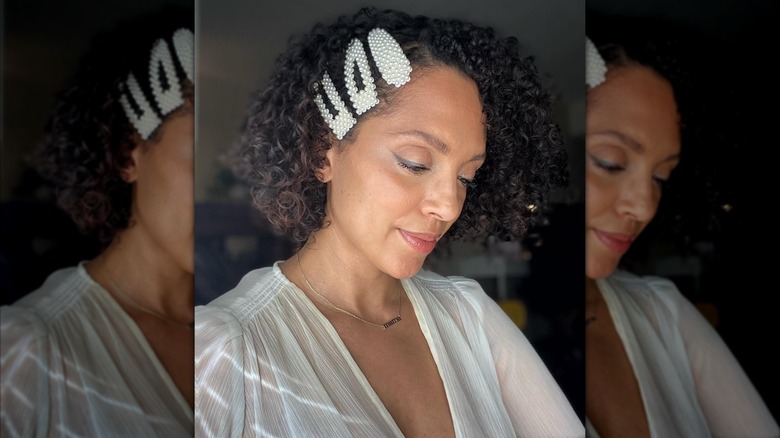 A woman with curly hair taking a selfie.