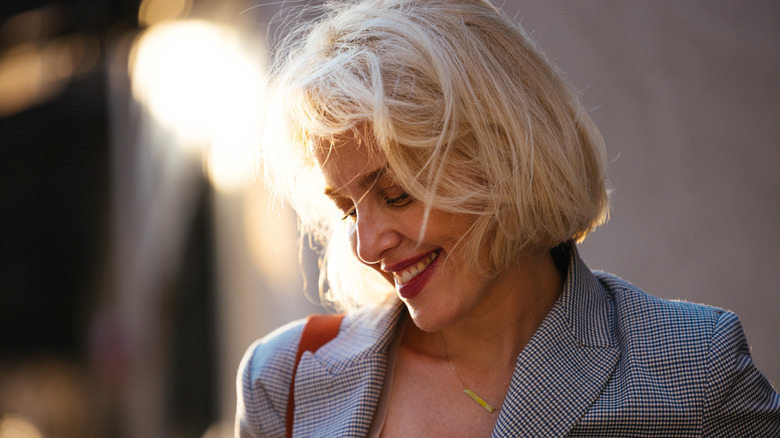 A woman with a bob haircut smiling.