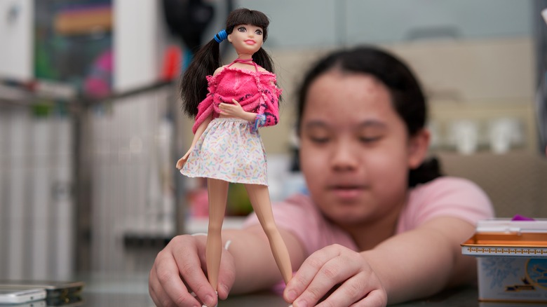Girl playing with Barbie
