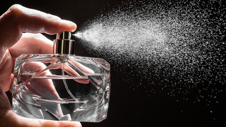 perfume spraying out of bottle