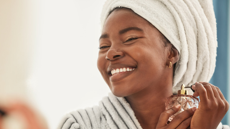 woman spraying perfume 