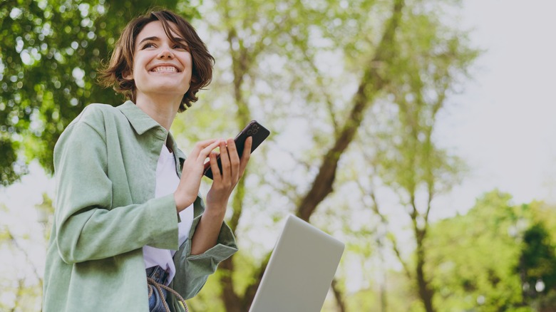 Woman smiling, working outside