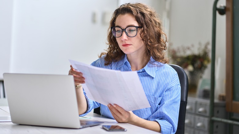 Woman working, looking at papers 