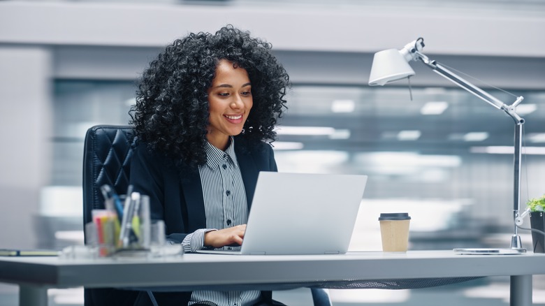 Woman smiling, working in office