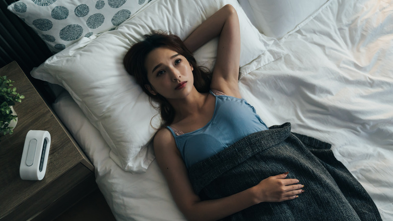 woman laying awake in bed