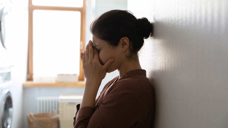 Woman covering face with hands