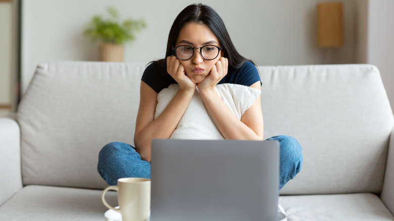 Woman on couch looking bored