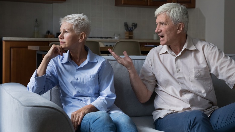 Older couple arguing on couch