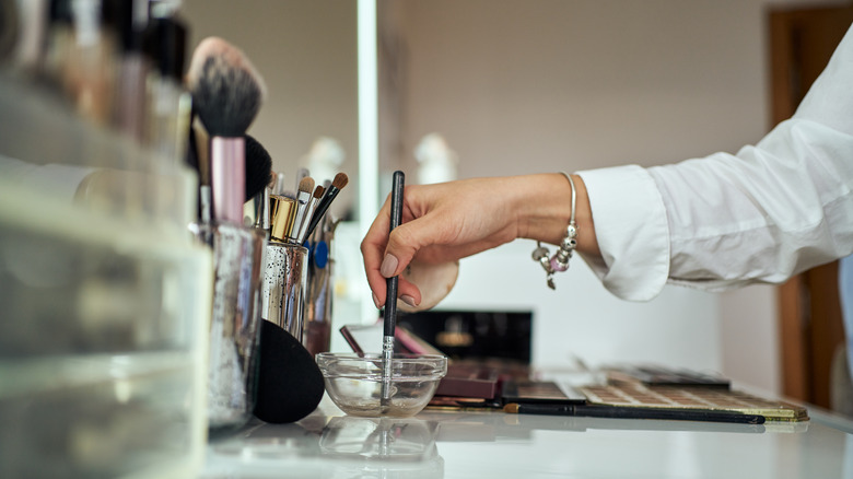 A woman cleaning her makeup brush