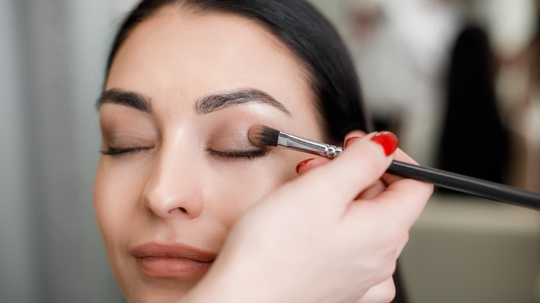 A woman getting her makeup done