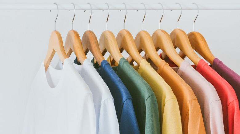 multicolored t-shirts on hangers