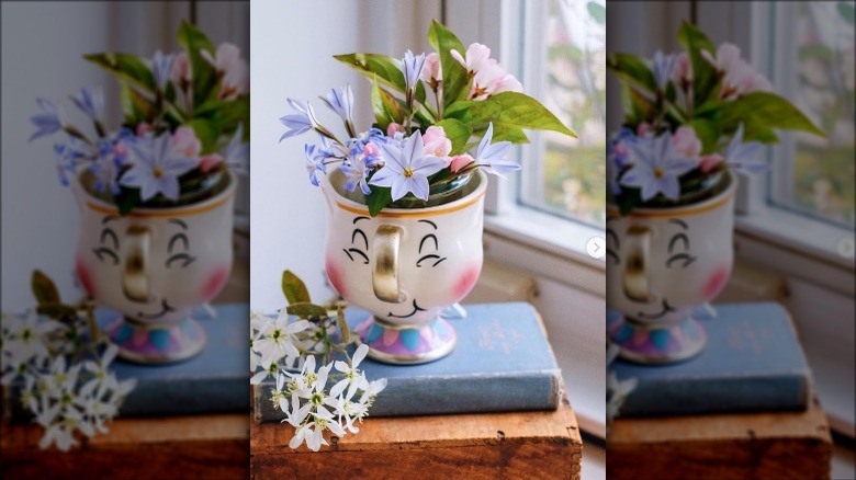 mug of flowers on book