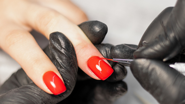 woman using nail art tool