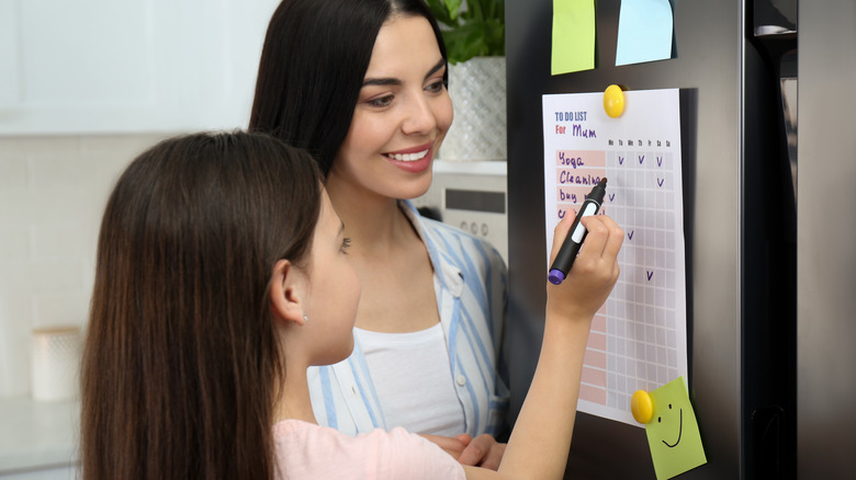woman looking at checklist with her daughter