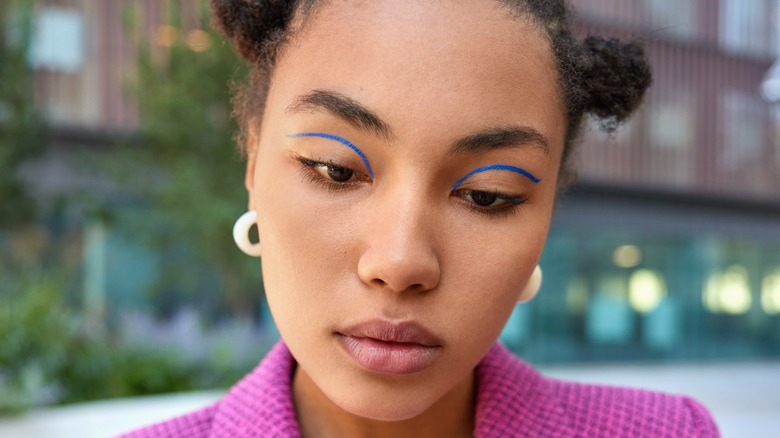 A woman wearing blue eyeliner