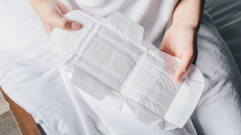 Woman holding clean pad