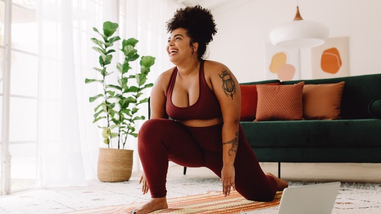 Woman doing yoga in living room