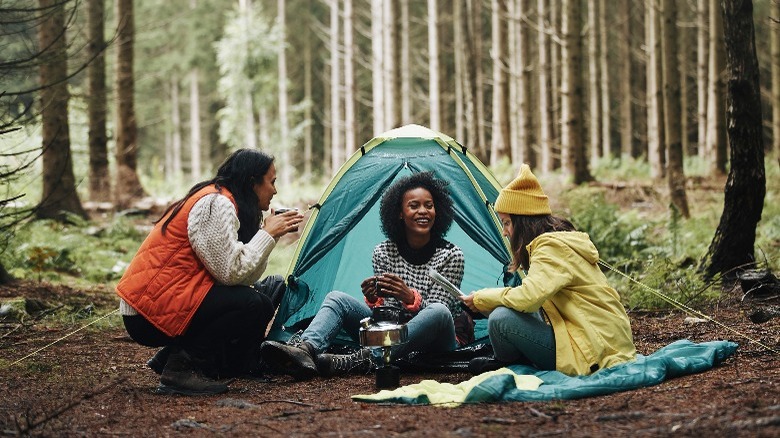 Three young women camping