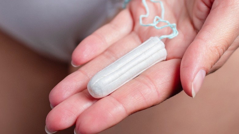 Women holding tampon in hand