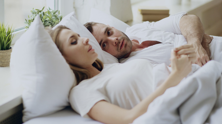 concerned couple in bed