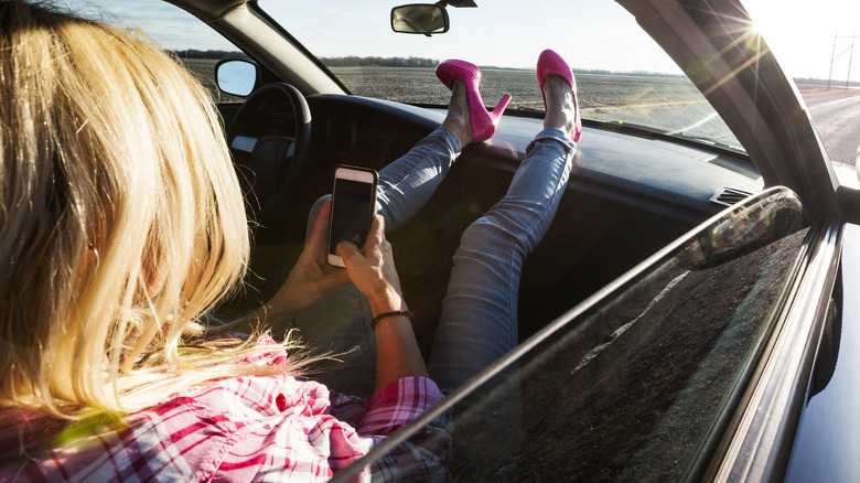 Woman wearing high heels in car