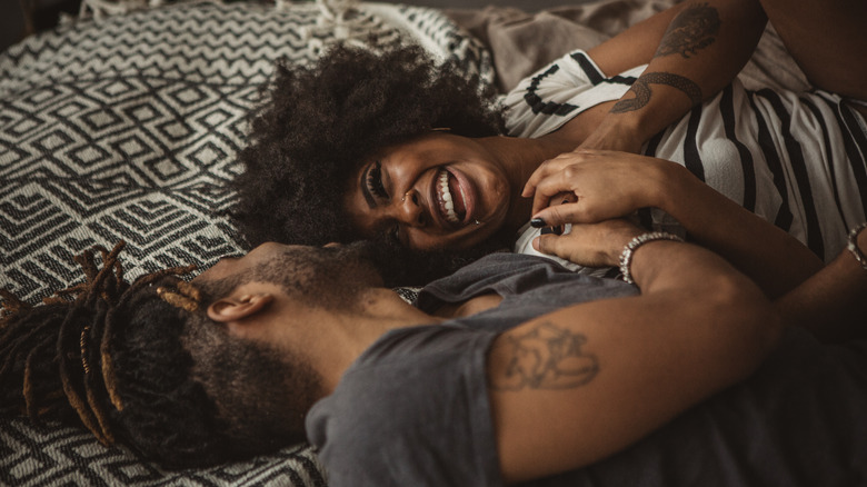 couple laughing in bed