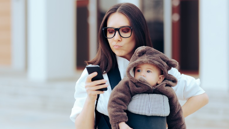 Upset mom looking at phone