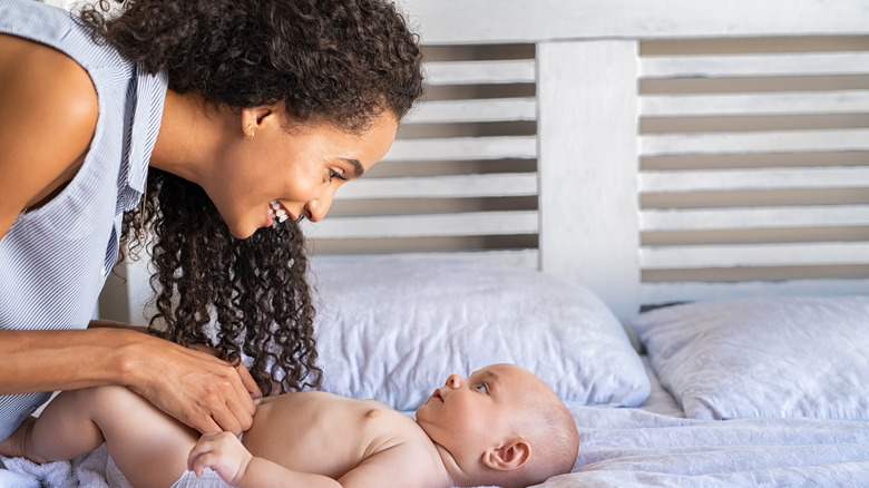 Woman playing with a baby