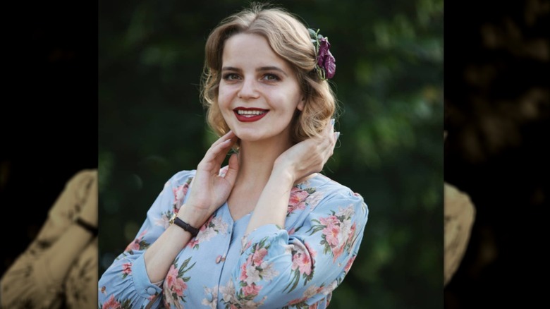 smiling woman in blue dress