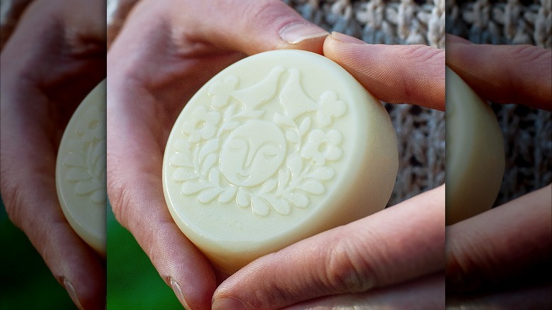 person holding engraved lotion bar
