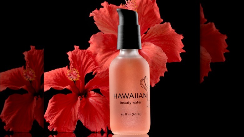 Face serum with hibiscus flowers