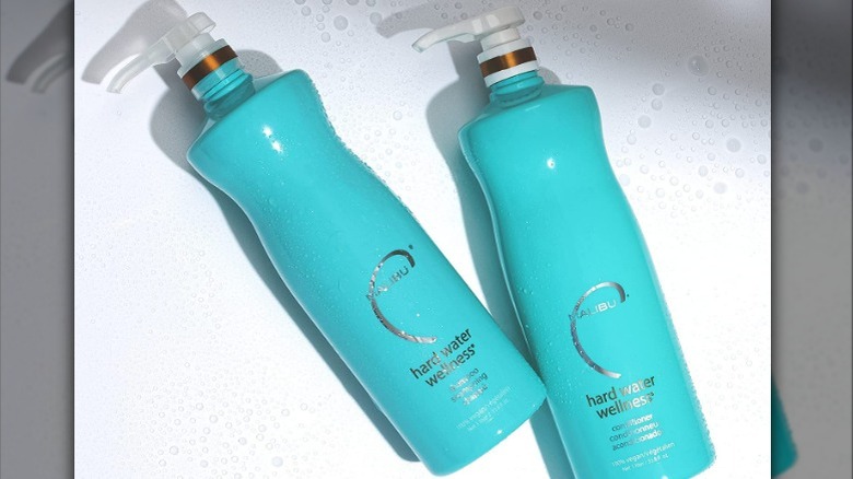 Two blue bottles of shampoo
