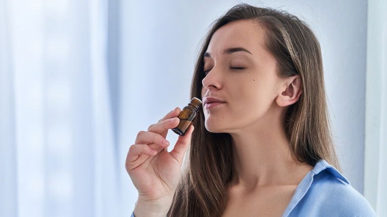 Woman smelling an herbal tincture 