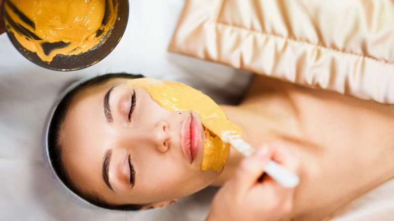 woman having a facial mask