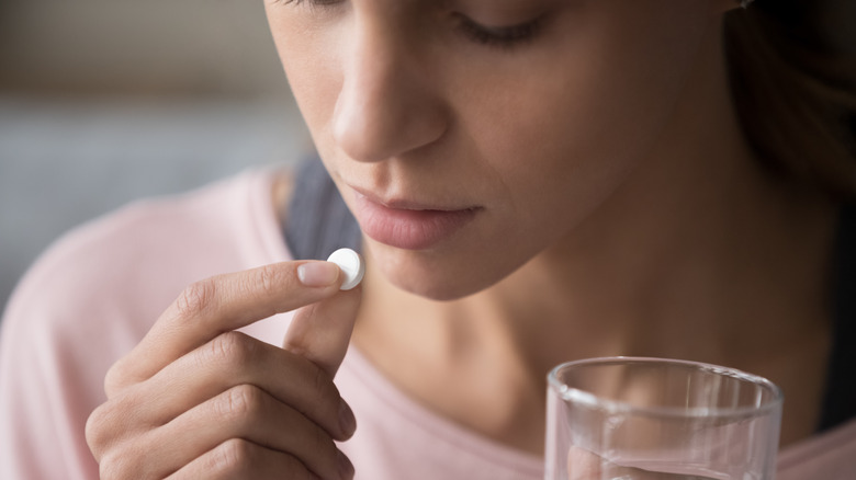 Woman taking a pill