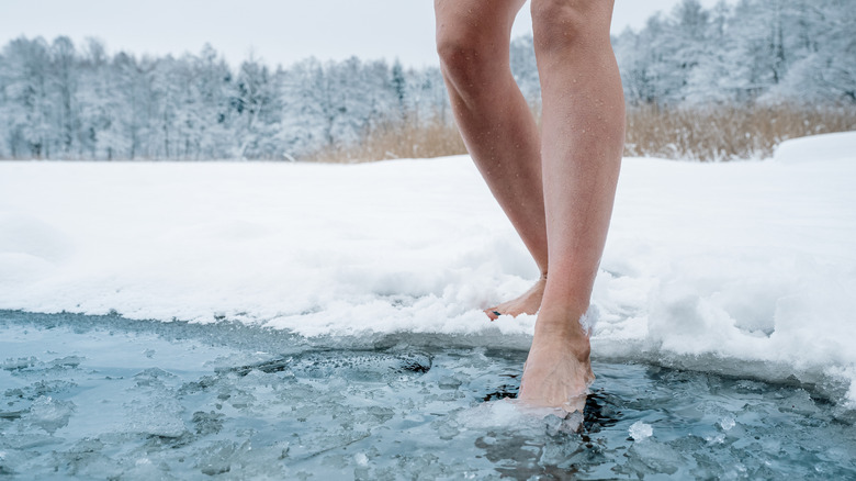 Woman stepping into ice water