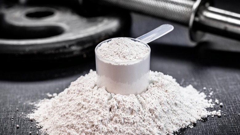 Creatine powder next to weights