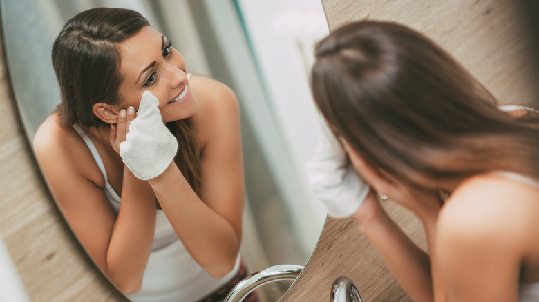 A woman removing makeup