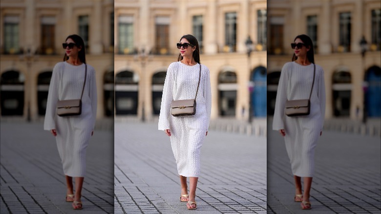 Person in white dress and gold sandals