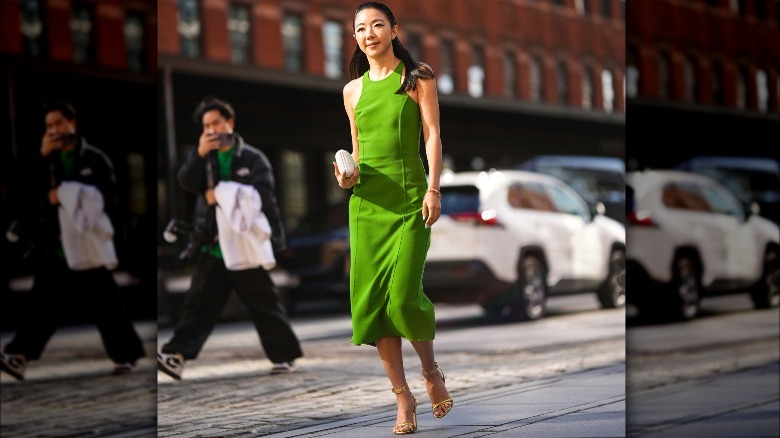 Person in orange outfit and gold sandals