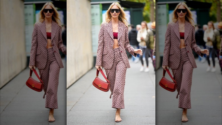 Woman in red suit and gold sandals