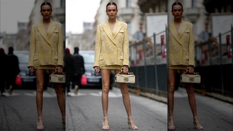 Person in yellow suit and sandals