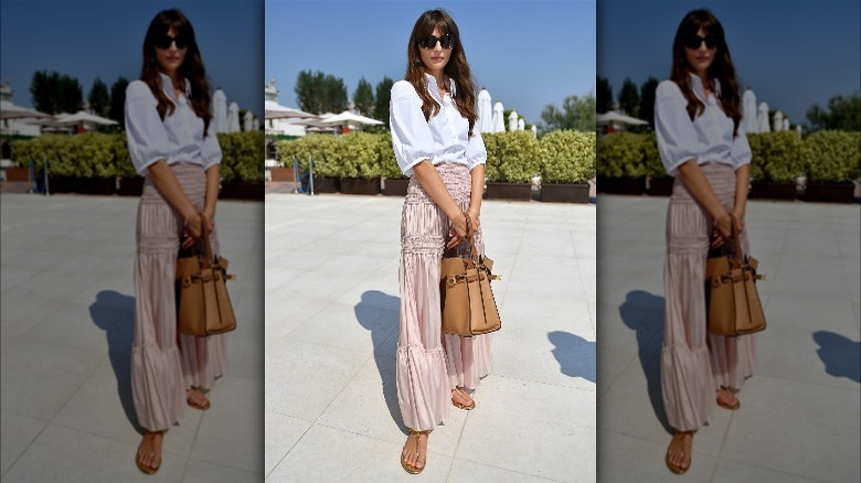 Person in white shirt and pink skirt