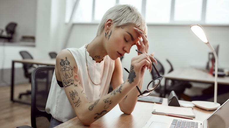 woman with tattoos and regret